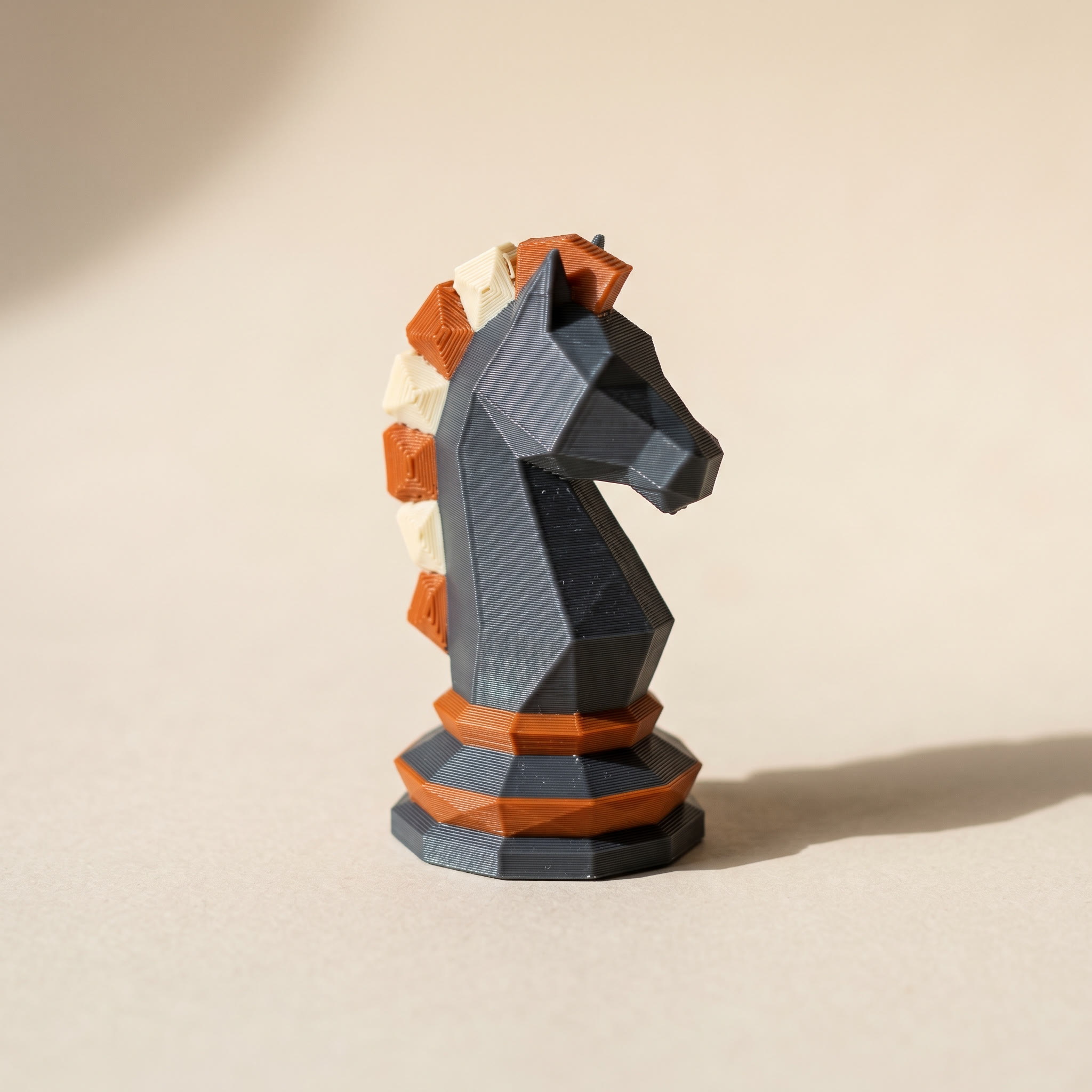 3MF vs STL in practice: a 3D printed chess knight with per-face color regions in charcoal, orange, and cream that only a 3MF file can store
