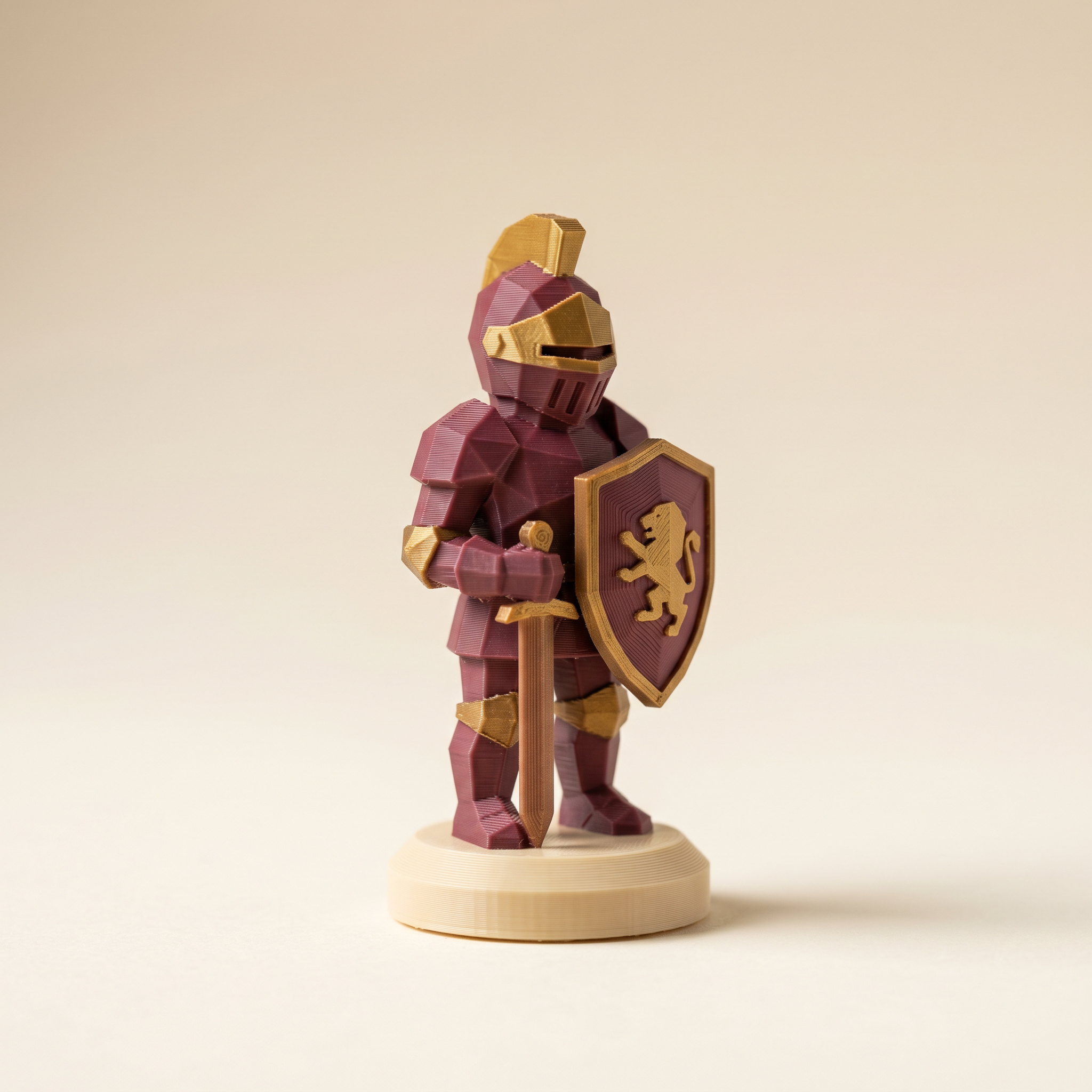 A multi-color FDM 3D-printed low-poly knight chess piece in matte burgundy armor, warm cream base, and brass-gold accents on cream paper