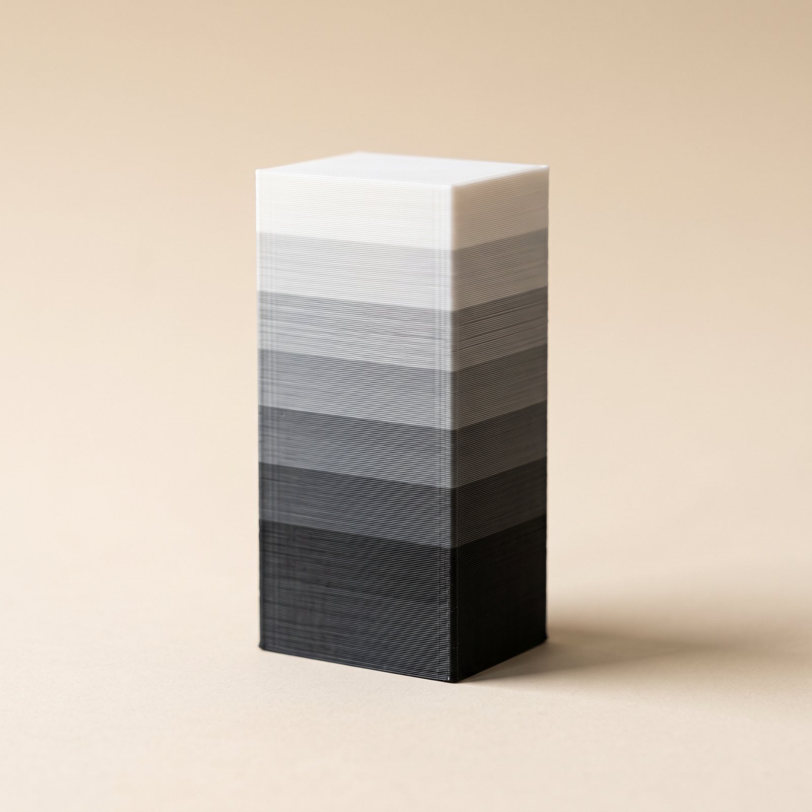 3D printed wipe tower block grading from black to white, the transition MMU3 color bleed leaves behind