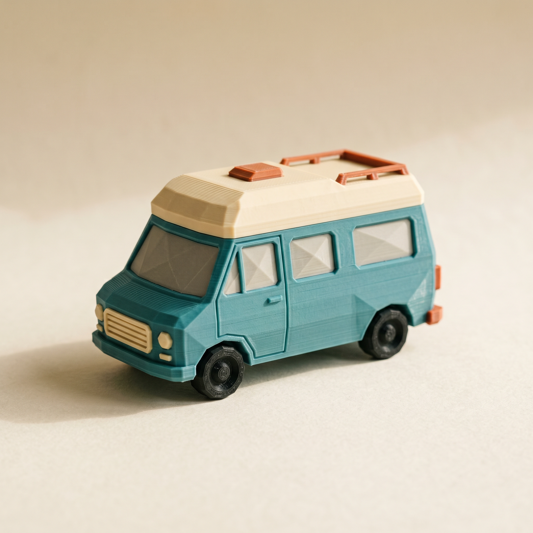 A small multi-color FDM 3D-printed low-poly camper van with a matte teal body, warm cream roof, and terracotta-orange accents on cream paper