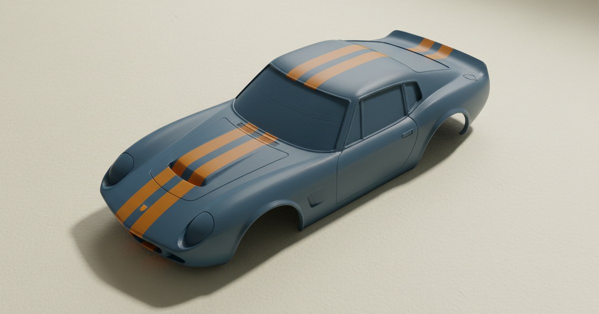Two crisp orange racing stripes on a 3D print of a classic car body shell in matte slate-blue filament, on cream paper