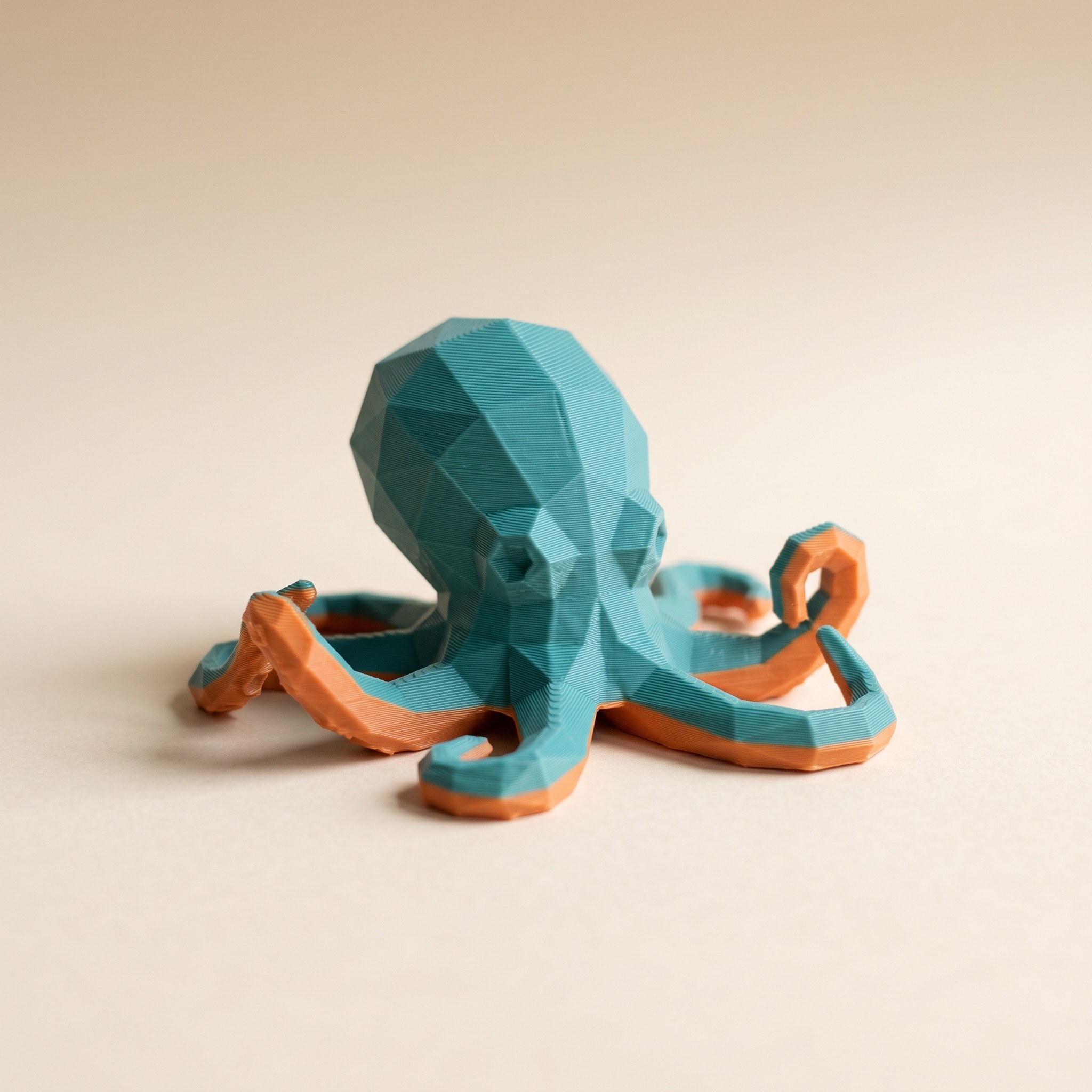 Two-color 3D-printed octopus figurine, the kind of print interrupted when a printer keeps purging at the color change