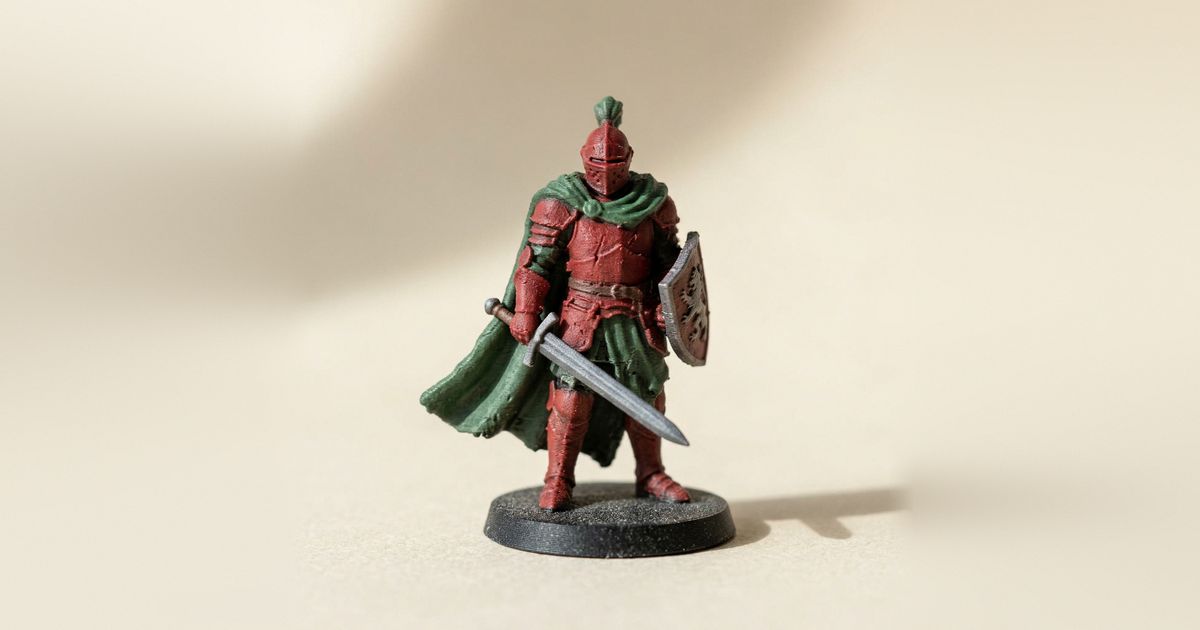 A 3D-printed knight miniature in red, green and grey filament
